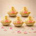Beige woven 10 inch handmade gift basket with gold trimmed sheer organza cover and pink rose accents for Indian events