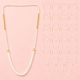 A delicate white beaded Barati Swagat Mala necklace with gold-toned accents and cascading fringe for wedding ceremonies
