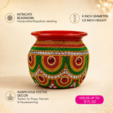 A vibrant red handmade mild steel decorative kalash with intricate green gold silver beaded patterns and gemstones for pooja