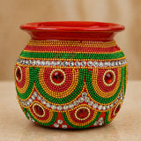Decorative kalash for pooja made of mild steel with vibrant red green and gold beads and ruby-red gemstones for festival decor