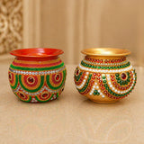 Two ornate hand-decorated mild steel puja kalash pots adorned with red green gold and white beads for festive decor
