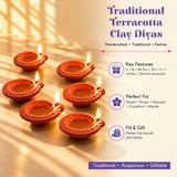 Handmade terracotta clay diya set with intricate hand-carved designs in warm orange-red for pooja and Diwali decoration