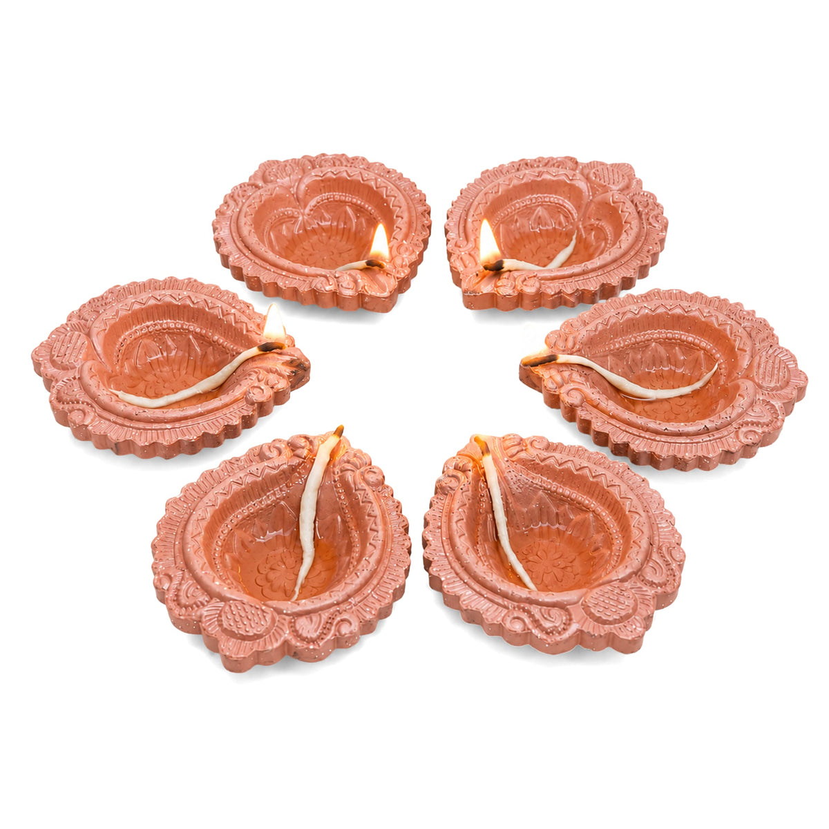 Six terracotta clay diyas with intricate floral and paisley patterns lit for pooja and diwali decoration
