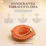 Handcrafted terracotta clay diya with intricate floral embossing and lit wick for pooja and Diwali decoration