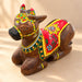 Hand-painted wooden nandi cow idol with vibrant red yellow and green floral patterns for home temple pooja decor
