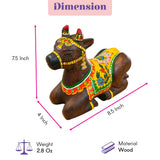 Hand-painted wooden nandi cow idol with vibrant yellow green and red patterns for home temple pooja decor