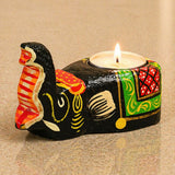 Hand-painted black ceramic elephant tea light holder with vibrant orange green and red patterns for home decor
