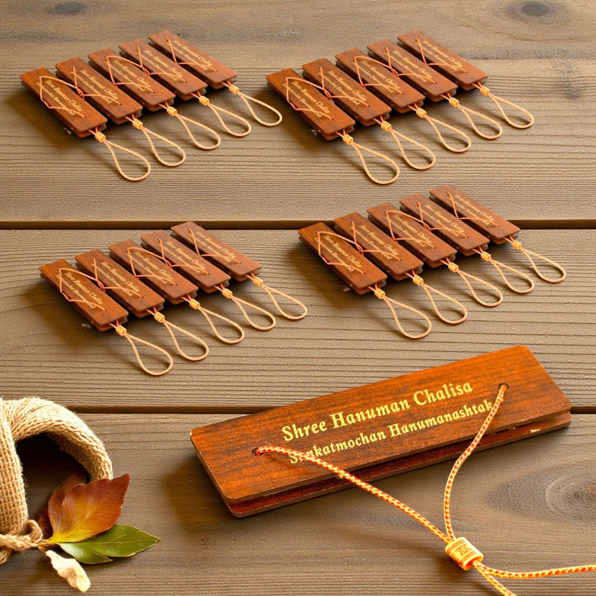 Brown wooden prayer beads with engraved text on Hanuman Chalisa book