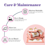 Stack of coral and white cotton napkins with embroidered elephant and floral prints