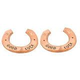 Two copper-colored horseshoe charms for rustic wedding and party decor