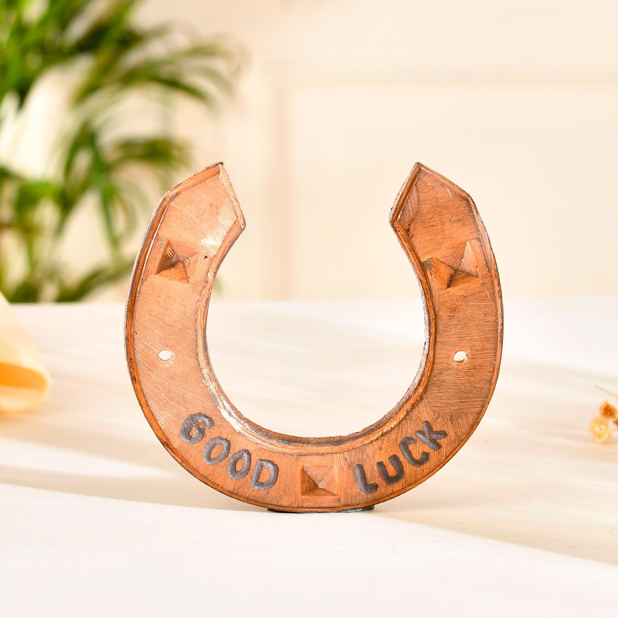 Copper-colored horseshoe with geometric designs for Western theme wall decor and party decoration
