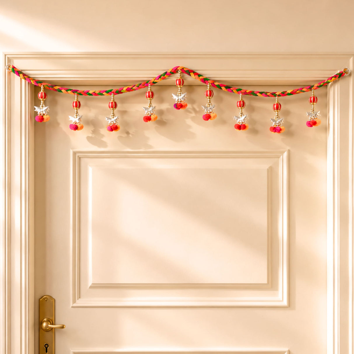Colorful braided rope traditional festive door toran garland with red beads silver stars and pink orange pom-poms for diwali