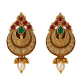 Golden ornate indian kundan chandbali earrings with red and green gemstones and pearl drops for diwali and weddings