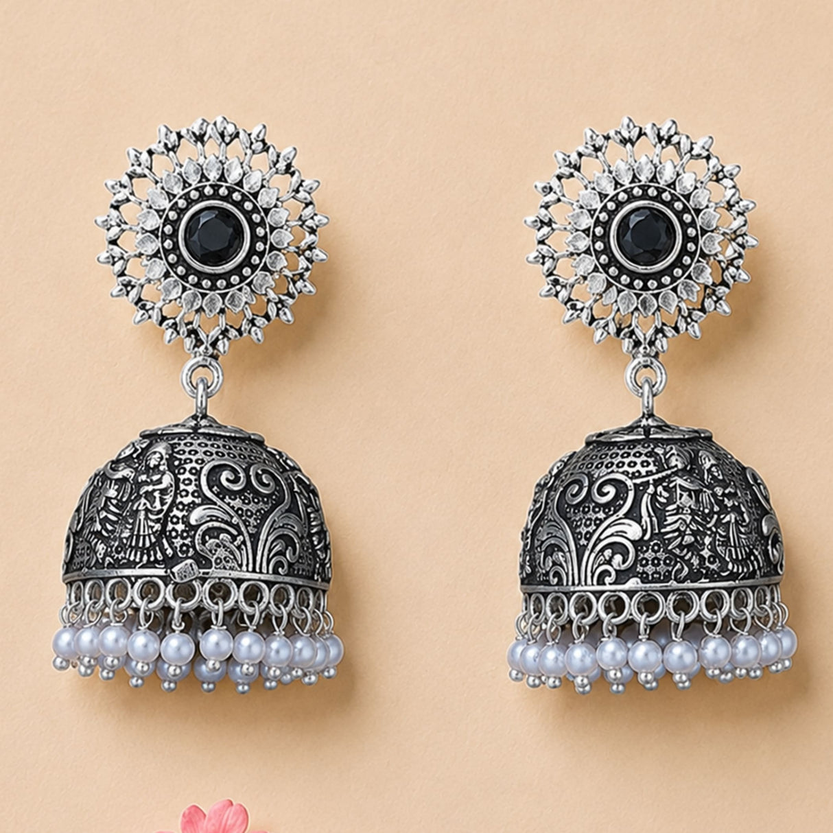 Silver jhumka earrings with intricate filigree, black gemstone, clear stones, and pearl dangle for ethnic wear