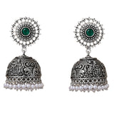 Boho oxidized silver-tone jhumka earrings with intricate filigree, green gemstone, clear stones, and pearl dangles for ethnic wear
