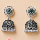 Boho oxidized silver tone jhumka earrings with intricate filigree, green gemstone, clear stones, and pearl dangles for ethnic wear