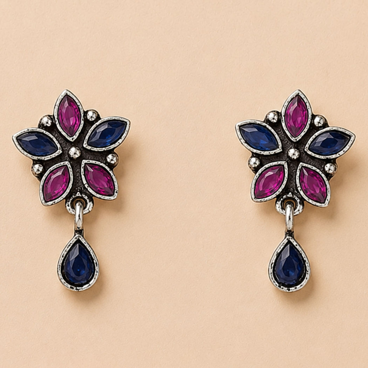 Indian oxidized floral silver earrings with magenta and deep blue stones for Diwali wedding and ethnic wear