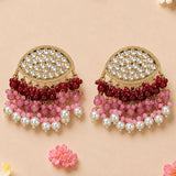 Gold tone indian kundan stone earrings with clear teardrop stones and red pink beads, perfect for diwali and weddings