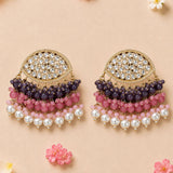 Elegant gold tone Indian Kundan stone and faux pearl chandelier earrings with purple pink beads for Diwali wedding wear