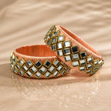 Peach satin Indian silk thread bangles with gold-trimmed mirrored squares for traditional bridal and gift use