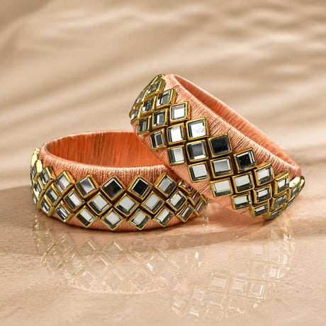 Peach satin Indian silk thread bangles with gold-trimmed mirrored squares for traditional bridal and gift use