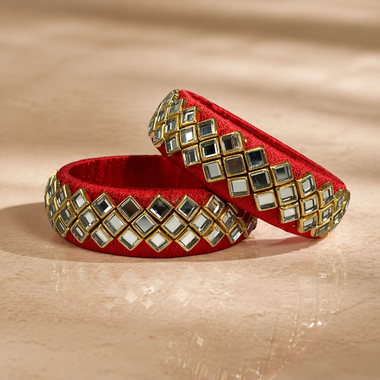 Indian silk thread bangles in red silk adorned with square mirrored stones in gold-toned frames for traditional wear
