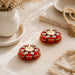 Red and gold decorative tea light candle holders adorned with clear rhinestones for festive home and temple decor