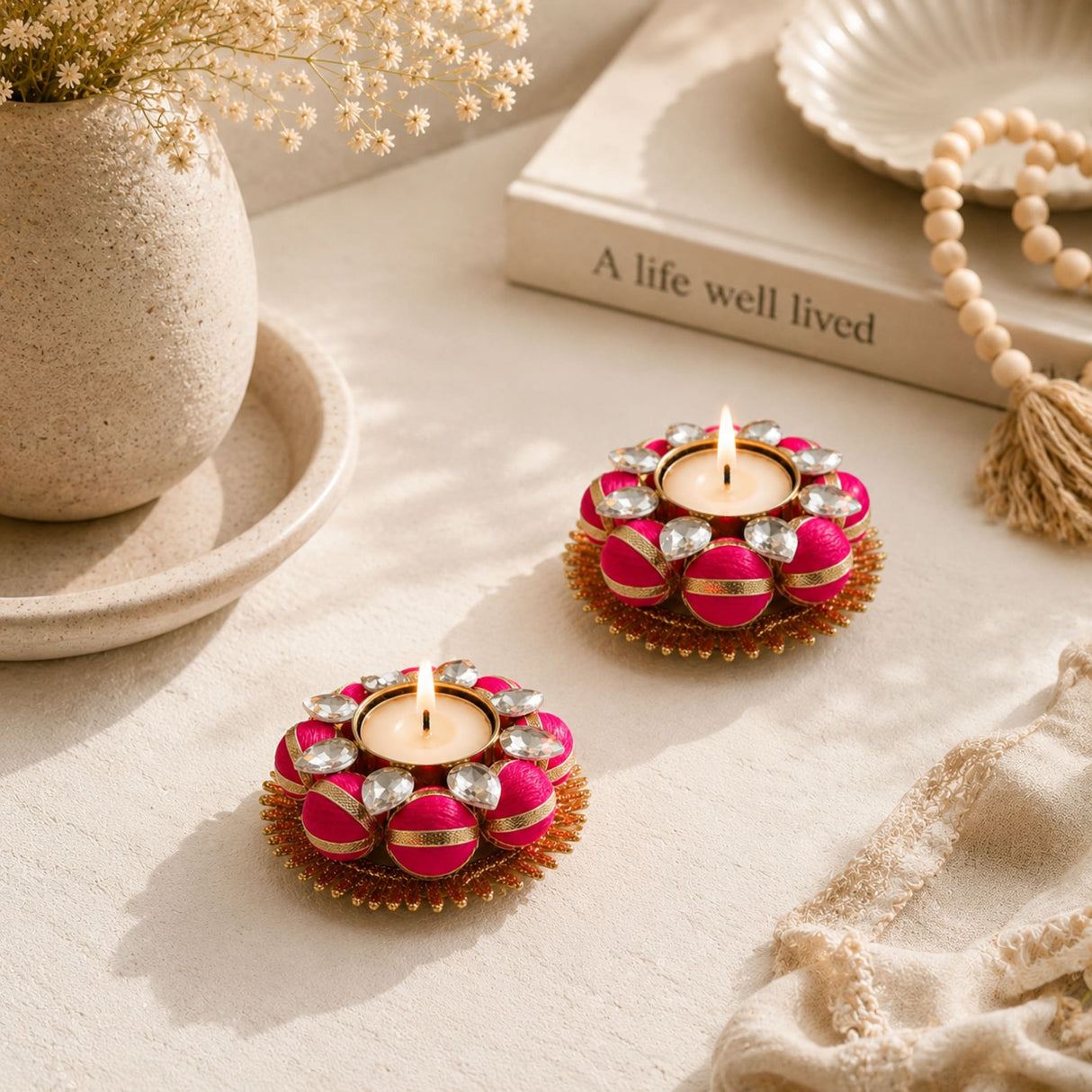 Vibrant pink and gold Indian tea light candle holders adorned with sparkling crystals for festive and home decor