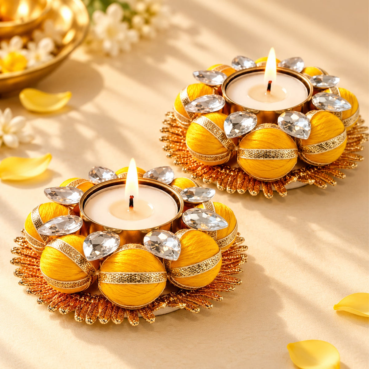 Two pack golden ornamental tea light candle holders with yellow fabric spheres and crystal accents for festive decor