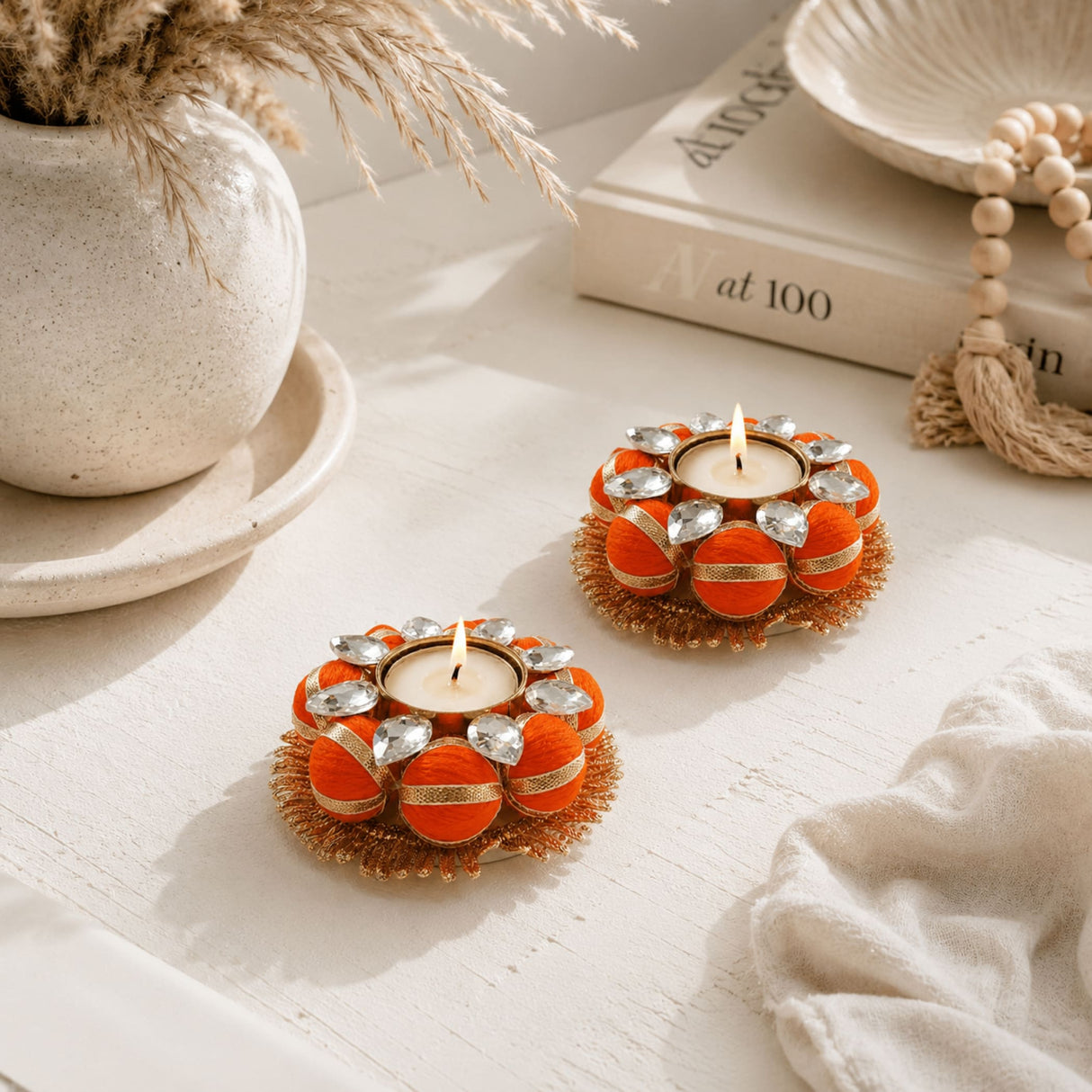 Orange and gold decorative tea light candle holders with clear crystal accents for home and festive decor