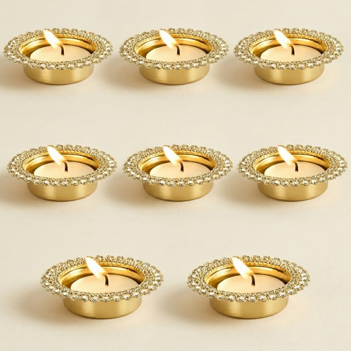 Gold-colored metal tea light candle holders with decorative beaded rim for home temple and festive decor centerpiece