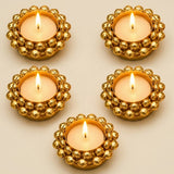 Golden beaded indian tealight candle holders with lit tea light candles for diwali christmas and pooja decor
