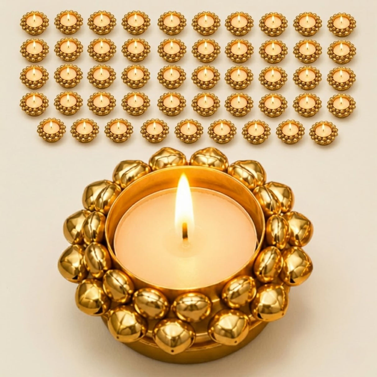 Golden ornate indian tealight candle holder with beaded design and lit candle for diwali pooja and christmas decor