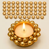 Golden ornate indian tealight candle holder with beaded design and lit candle for diwali pooja and christmas decor