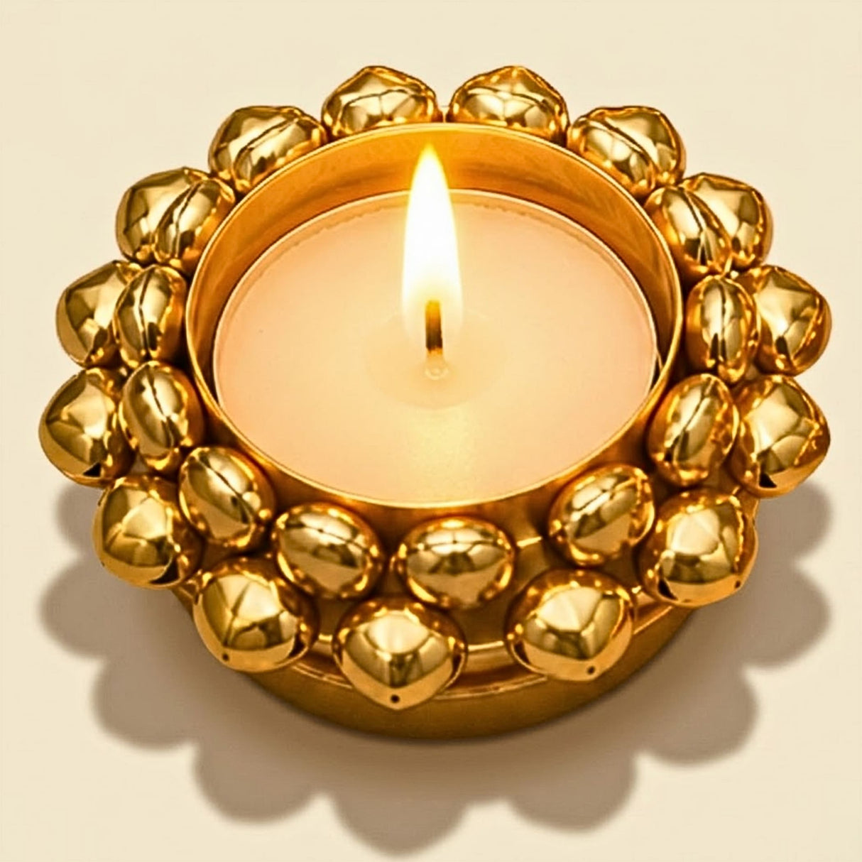 Golden metallic indian tealight candle holder with circular polished bead design for diwali and christmas decor