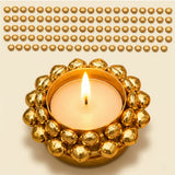 Golden ornate indian tealight candle holder with lit tea light used for diwali christmas and pooja decorations