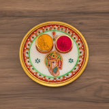 Ceramic Ganesh puja thali with vibrant colors and intricate designs for Indian Pooja decor