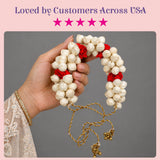 Traditional artificial jasmine gajra for hair featuring delicate white and red flowers with gold-toned tassels and bells