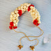 Traditional artificial jasmine gajra cream and red floral headpiece with small bells and twisted gold cord for bridal hair