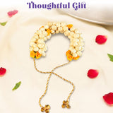 Traditional artificial jasmine gajra with white and yellow flowers, gold-toned twisted cord, and bell charms for bridal hair