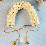 Cream-colored traditional artificial jasmine gajra made of clustered floral blossoms with gold-toned beads and bells