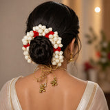 Traditional artificial jasmine gajra hair accessory with white and red blossoms gold chains and bells for bridal mehndi weddings