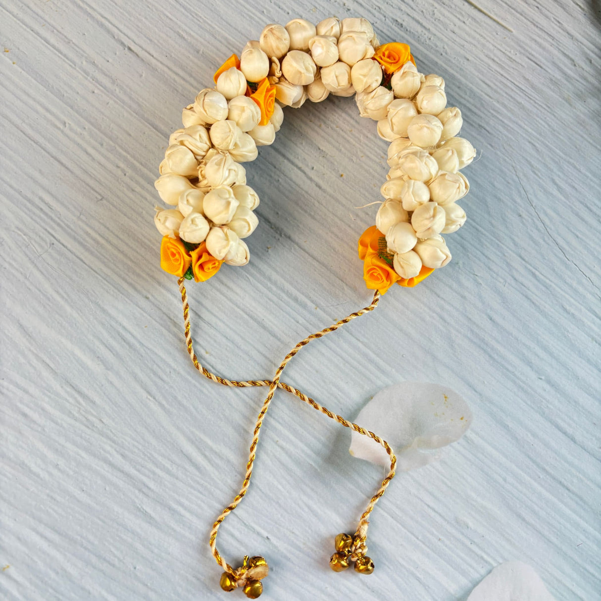 Traditional artificial jasmine gajra in cream and yellow with gold tassels and bells for bridal mehndi and weddings