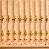 White floral garlands with colorful parrot and fruit motifs gold accents and tassels for indian wedding decor and pooja backdrop