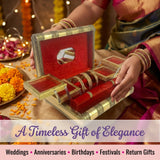 Gold-trimmed jewelry box with red velvet interior, mirrored lid, bangles holder