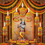 Golden flute-playing deity statue with ornate jewelry and floral garlands for Indian themed party decor