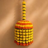 A vibrant jumbo artificial marigold flowers jhoomar in bright yellow and orange for indian and mexican themed decor