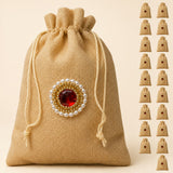 Beige jute potli bag with red gemstone embellishment and gold beads for eid gifts and wedding favors