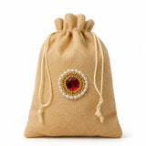 Beige jute potli bag with drawstring and red gemstone pearl embellishment for indian wedding and eid gifts