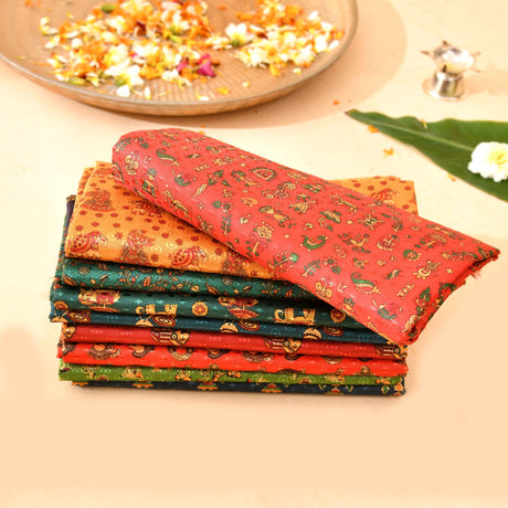 Stack of unstitched kalamkari multicolor blouse pieces with vibrant paisley patterns for saree and indian return gifts